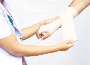 doctor bandaging patient's hand